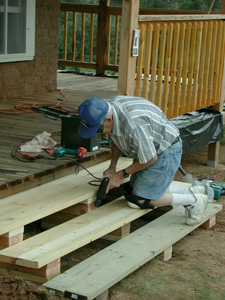 Photo - Jack Glenn working on porch steps.